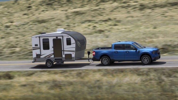 The 2025 Ford Maverick seen in profile, towing a camper