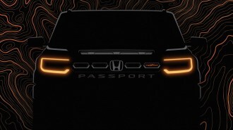 A teaser photo showing the front end of the 2026 Honda Passport, in heavy shadows