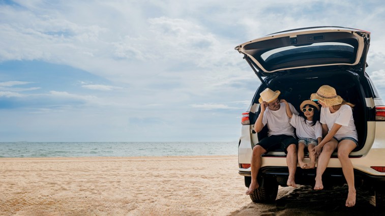 Car on the beach with family.