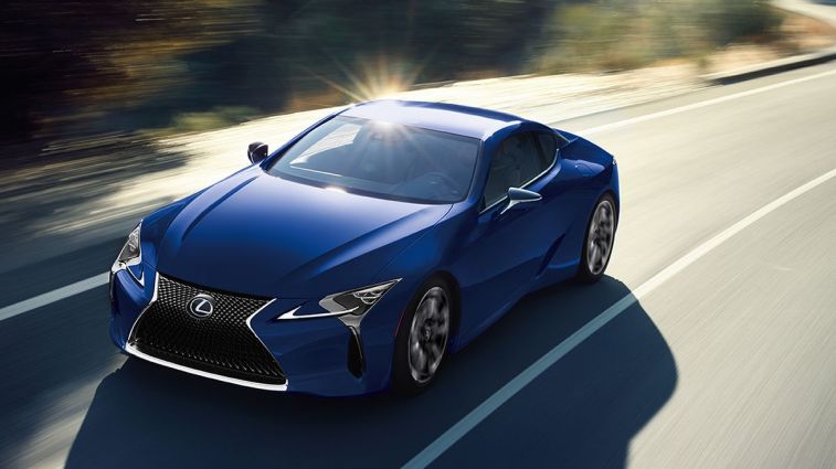 2024 Lexus LC 500h in blue driving on a road.