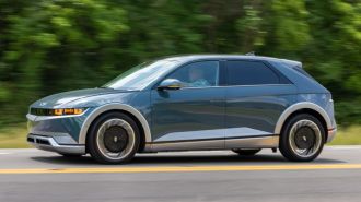 2024 Hyundai Ioniq 5 in blue driving on a road.