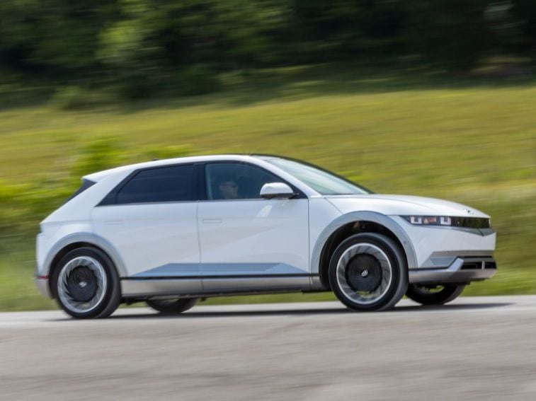 2024 Hyundai Ioniq 5 in white driving on a road.