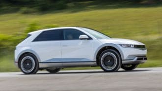 2024 Hyundai Ioniq 5 in white driving on a road.
