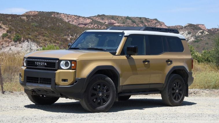 2024 Toyota Land Cruiser First Edition in Sand with red hills in the background.