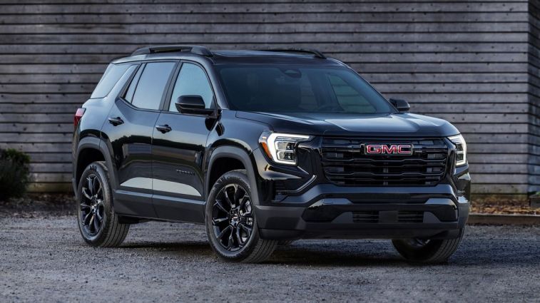 2025 GMC Terrain Elevation in black parked next to a barn.