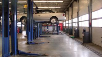 2-post car lifts in a repair shop.
