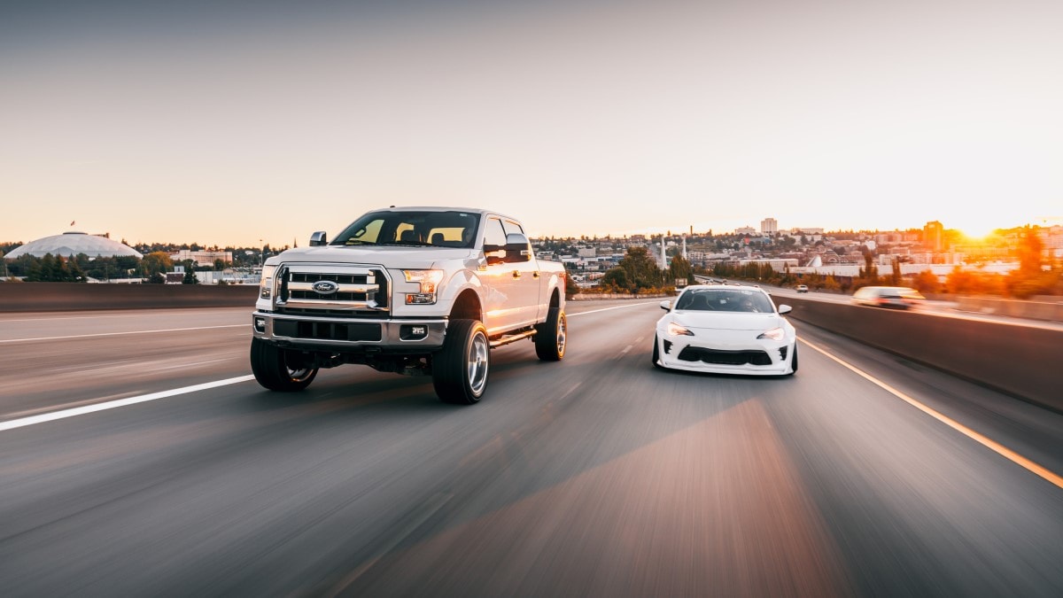 A Ford pickup next to a Nissan Z
