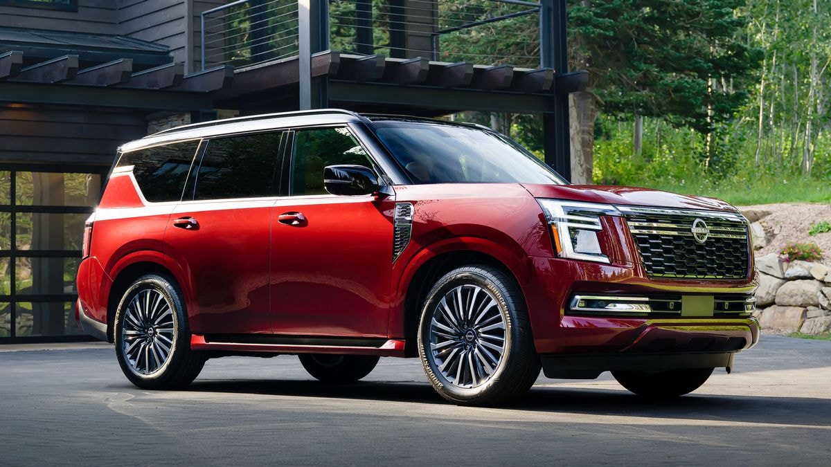 2025 Nissan Armada Platinum Reserve parked in front of a cabin.