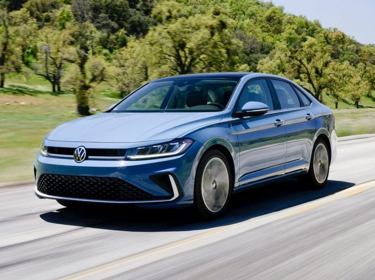 2025 Volkswagen Jetta driving on a road.
