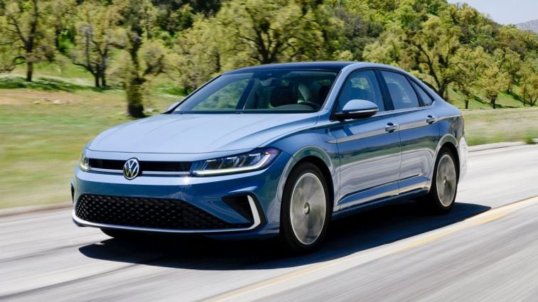 2025 Volkswagen Jetta driving on a road.