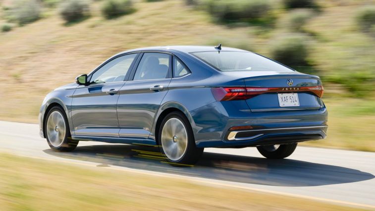 2025 Volkswagen Jetta driving on a road.