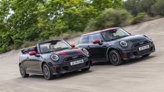 The 2025 Mini John Cooper Works hardtop and convertible models side by side, seen from a front quarter angle