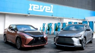 A Lexus RZ and a Toyota bZ4X parked at a Revel charging station