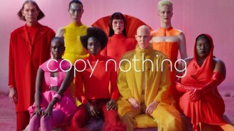 A still image from a new Jaguar ad campaign showing models behind the phrase "copy nothing"