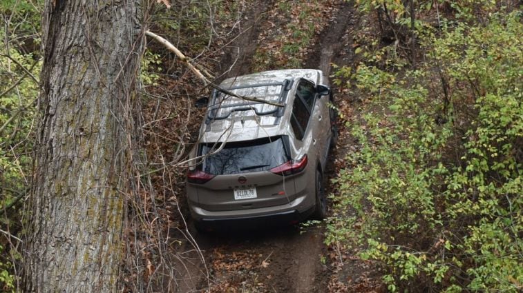 2025 Nissan Rogue Rock Creek Edition driving uphill.