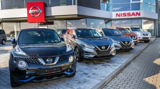 Cars parked outside a Nissan dealership