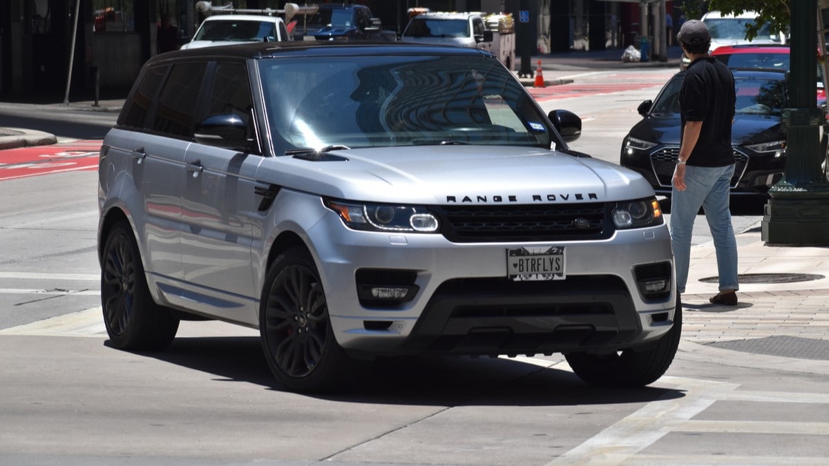 A pedestrian next to a Range Rover