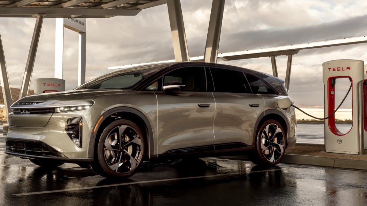 The 2025 Lucid Gravity plugged into a Tesla Supercharger.