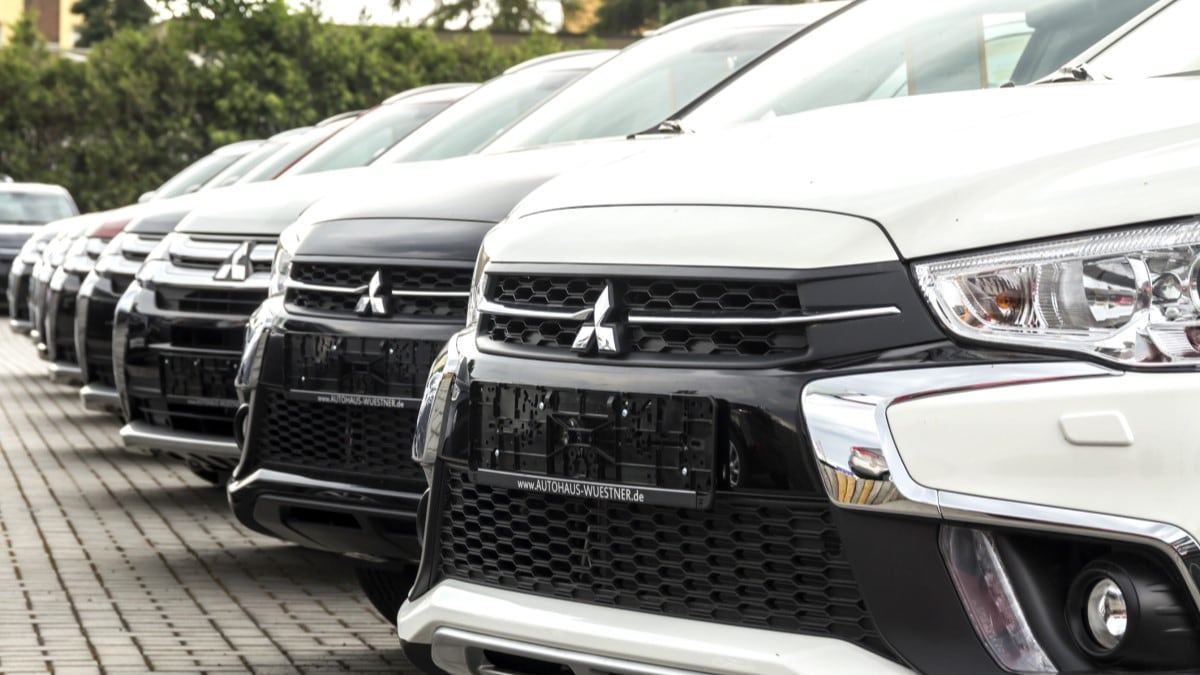 A line of cars at a Mitsubishi dealership