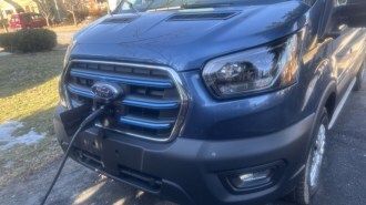 The 2025 Ford E-Transit, plugged in to charge
