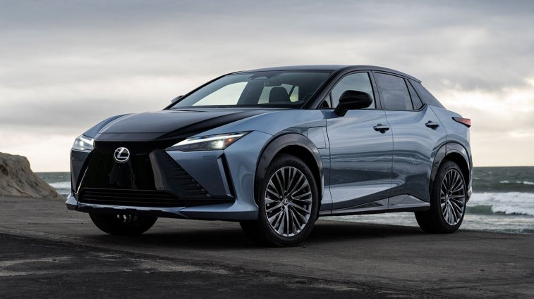 2025 Lexus RZ parked on the beach near the ocean.