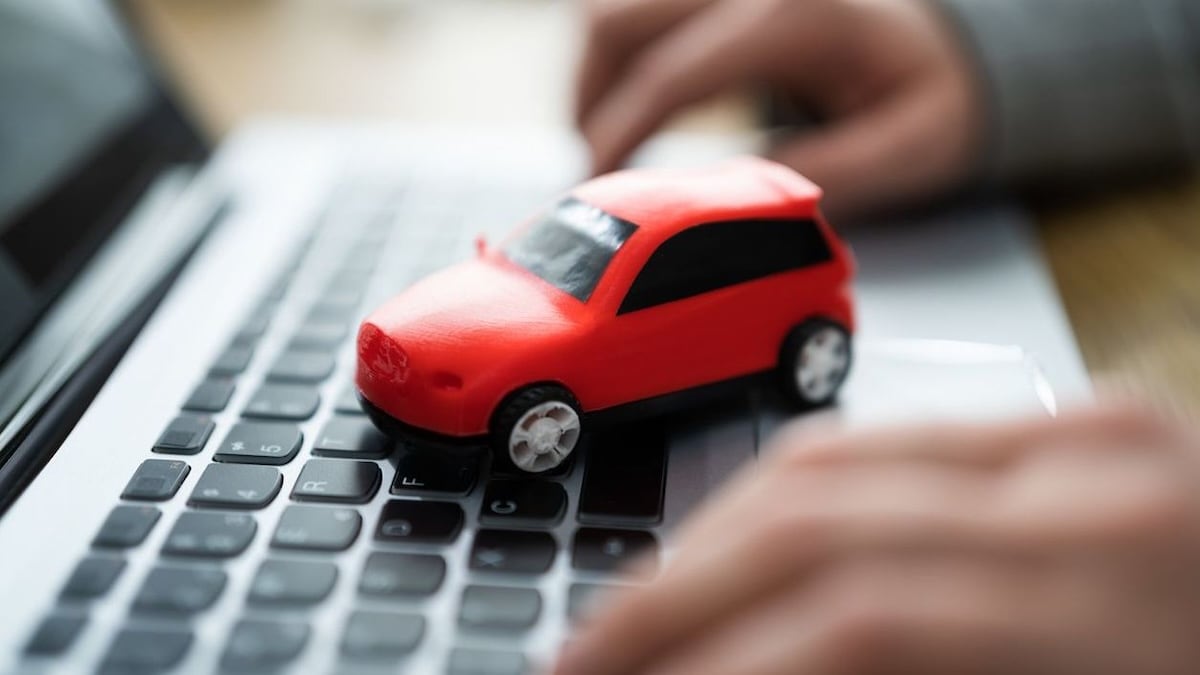 Toy car on laptop keyboard
