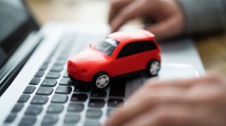 Toy car on laptop keyboard