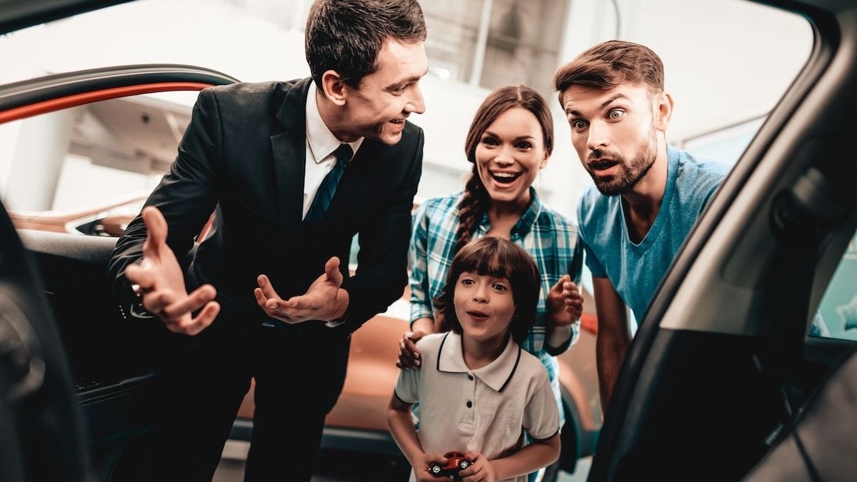Surprised car shopper looking inside vehicle