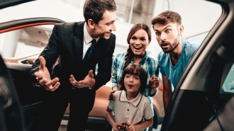Surprised car shopper looking inside vehicle
