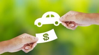 One hand holding money and another holding a car.