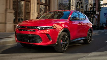 2025 Dodge Hornet R/T in Hot Tamale driving through the city.