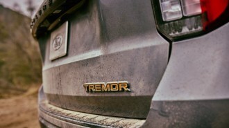 A teaser image showing the tailgate badge of the 2025 Ford Explorer Tremor