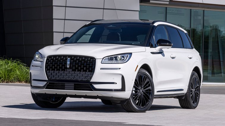 2025 Lincoln Corsair in white, parked in front of a building.