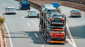 A car carrier loaded with new cars on a highway
