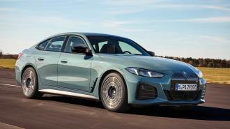 2025 BMW i4 M50 xDrive driving on a highway.