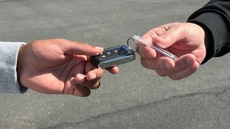 Person handing car keys over to new owner