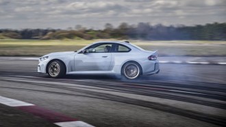 The 2026 BMW M2 CS seen in profile, drifting