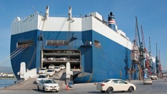 cars exiting a roll-on/roll-off container ship