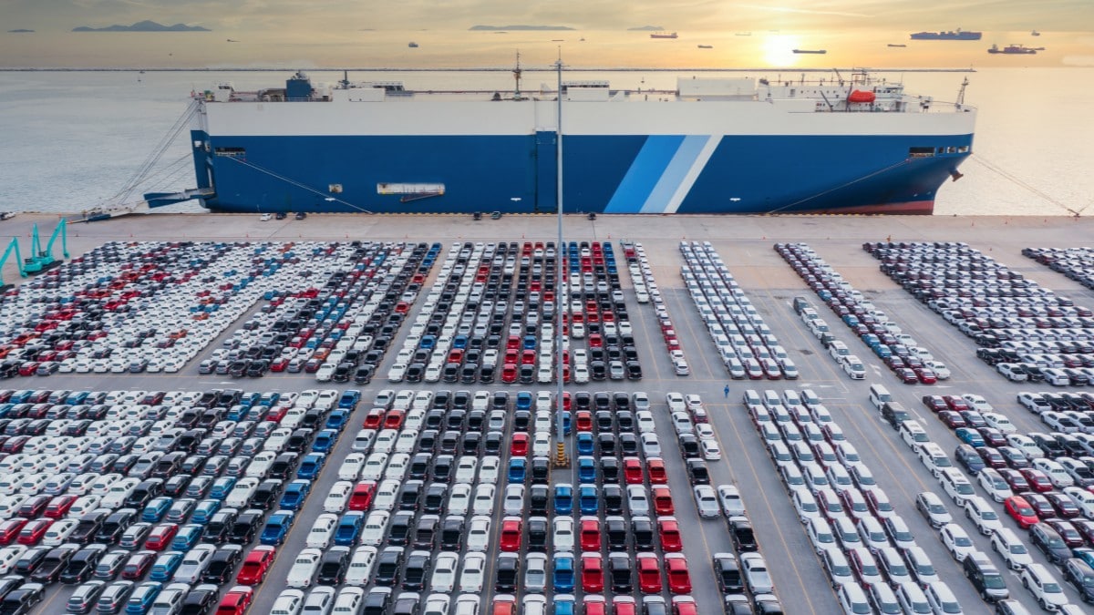 cars parked in port near the ship that delivered them