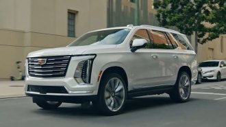2025 Cadillac Escalade driving through the city.