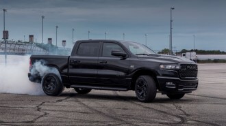 The 2026 Ram 1500 with the optional Hemi V8 seen in profile with smoking tires